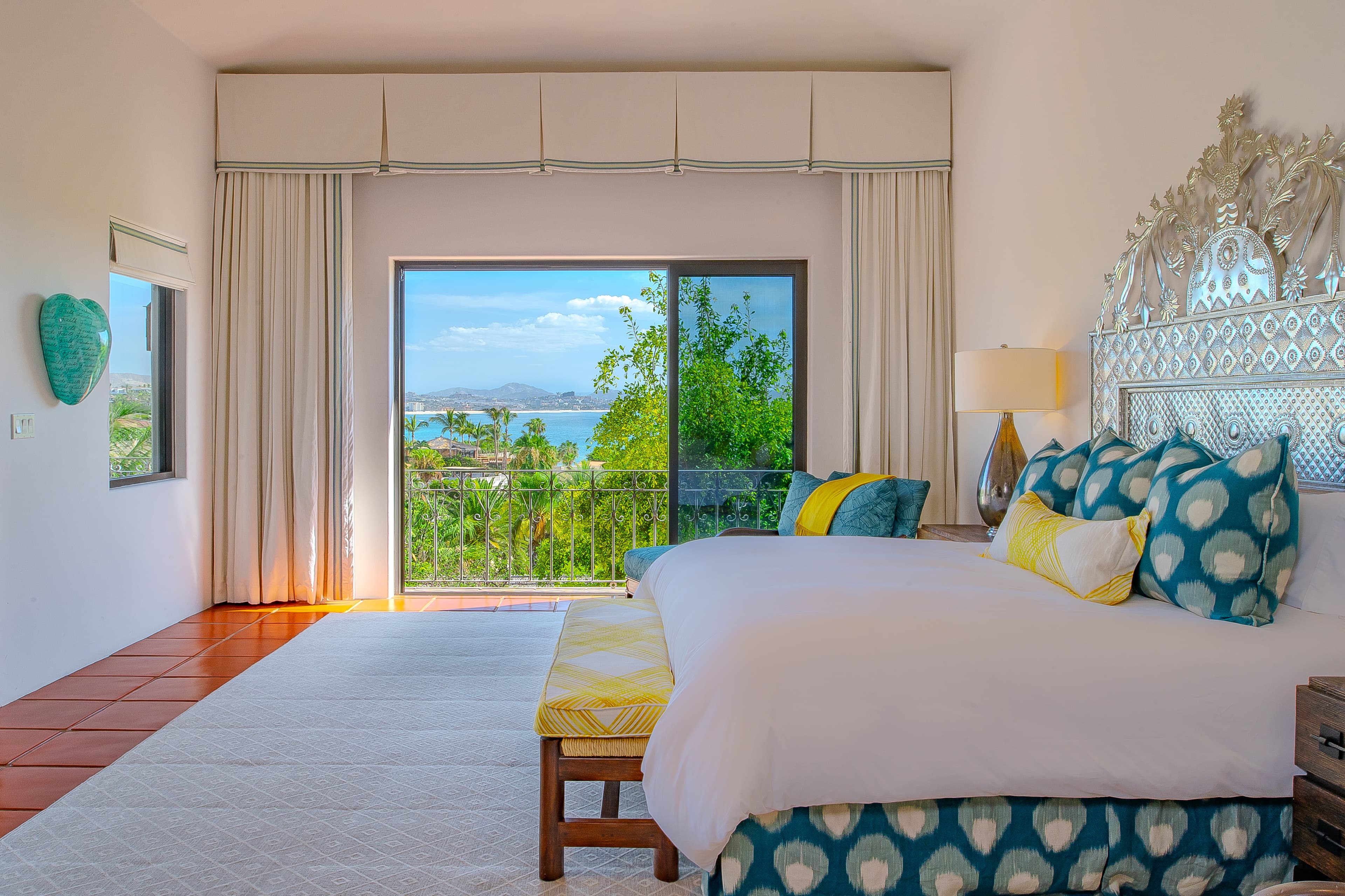 Bedroom 3 · Wake up to stunning coastal views framed by your private balcony, where turquoise waters meet lush tropical greenery and distant mountain horizons create your perfect escape.