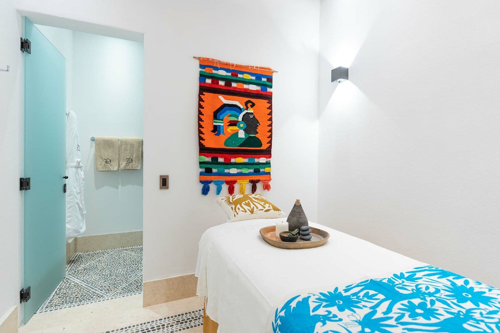 The massage room of this home, with the door to the personal sauna open.