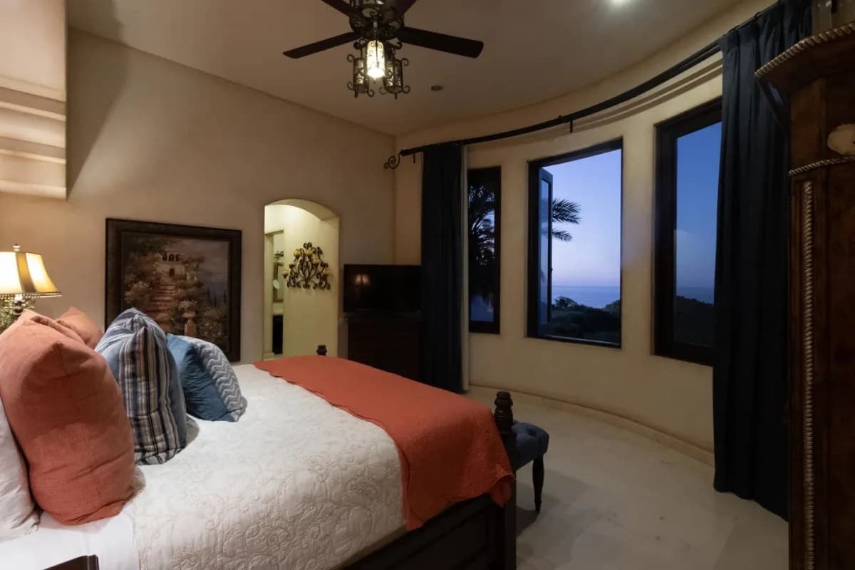 Bedroom 6 · Drift off in your cozy bedroom as tropical breezes flow through windows framing stunning ocean views—your perfect retreat after a day of adventure.