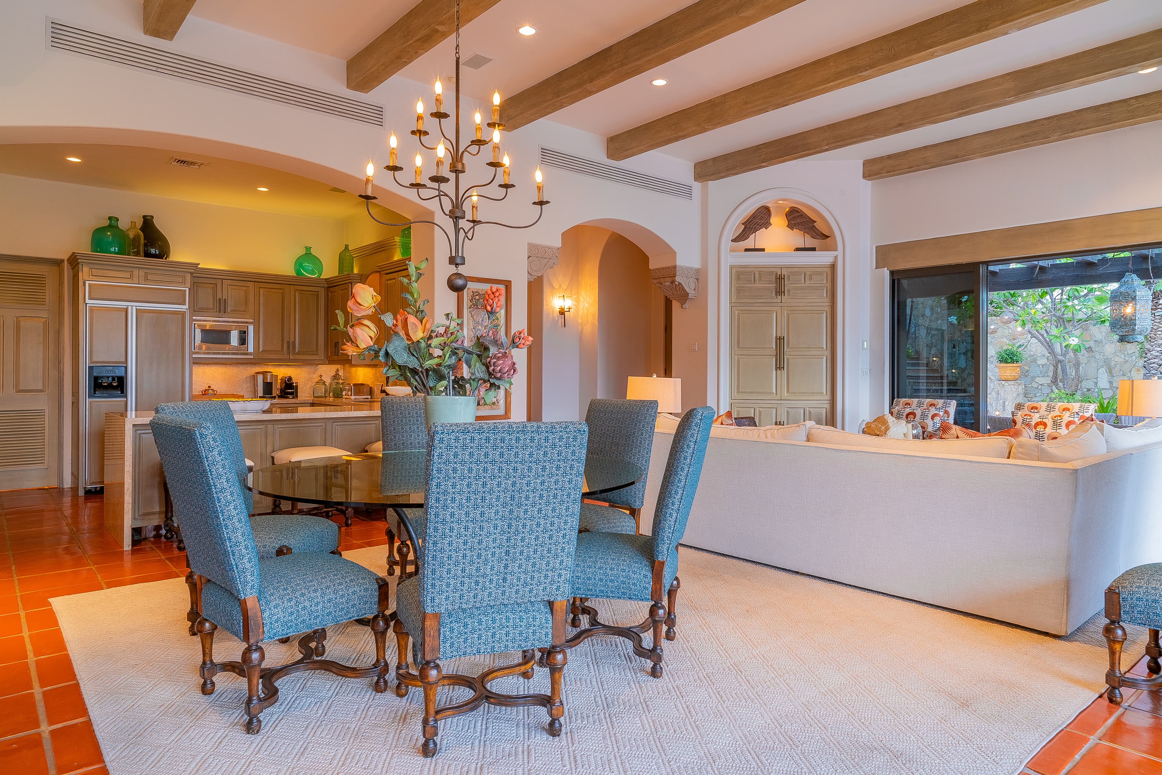 Gather around the elegant dining table where rustic wooden beams meet Mediterranean charm. Your open-plan kitchen awaits, perfect for creating memorable meals and conversation.