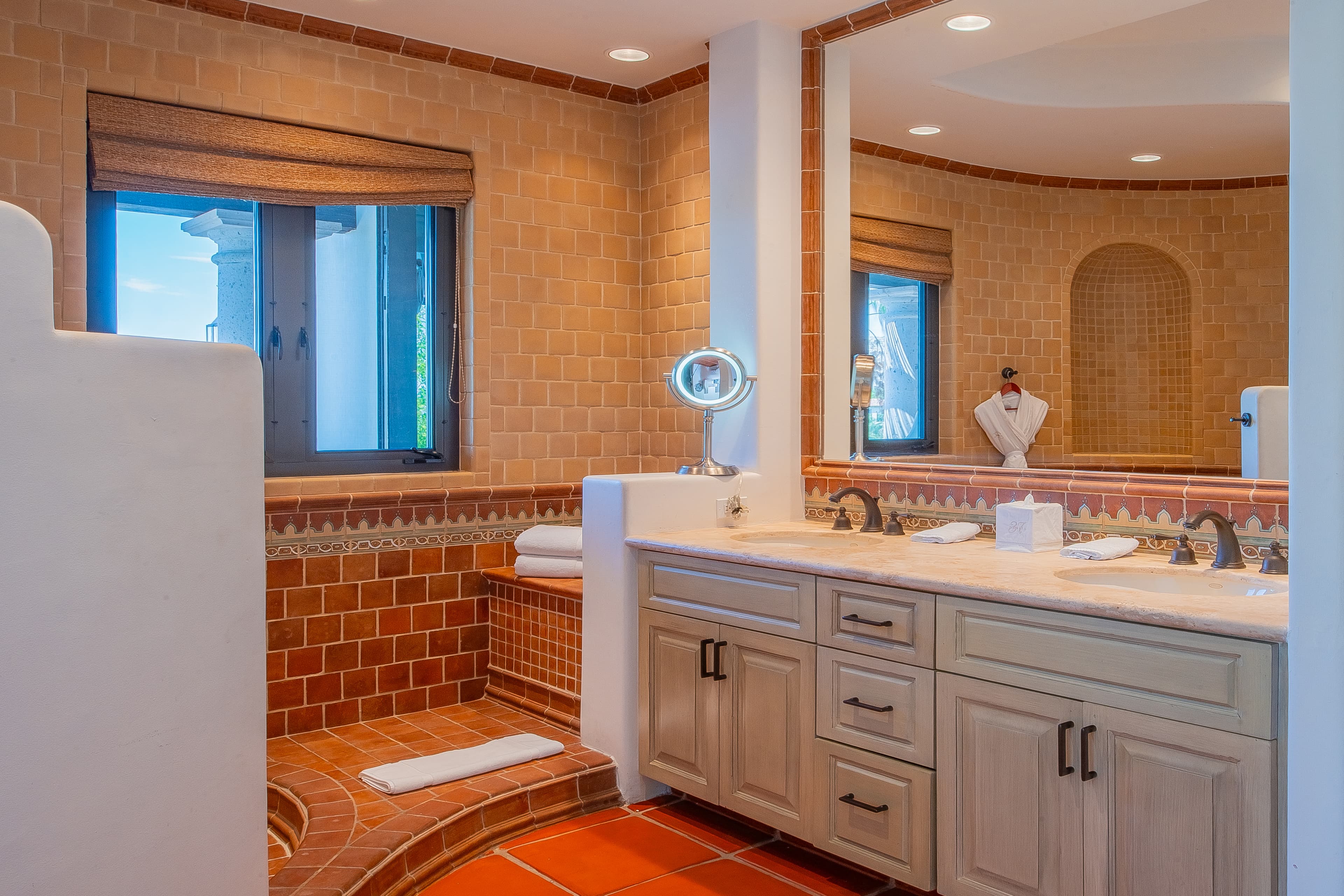 Bathroom 1 (Master ensuite) · Unwind in this beautifully tiled bathroom with warm terracotta tones, dual vanity, walk-in shower, and natural light for your perfect morning routine.