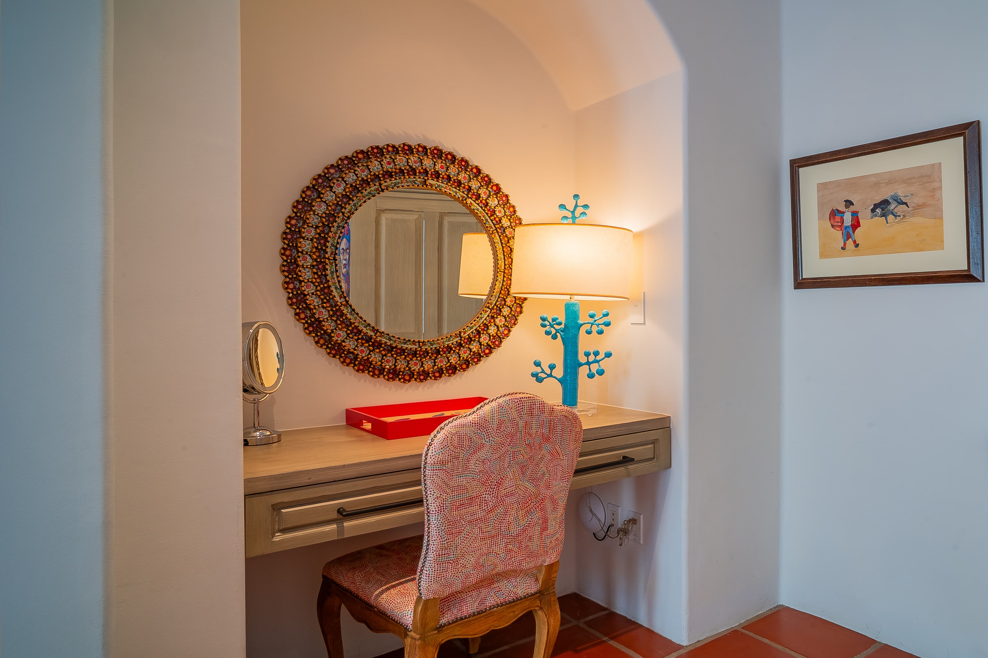 Settle into your private vanity nook, where warm lighting and a handcrafted mosaic mirror create a cozy space to start your mornings with ease.