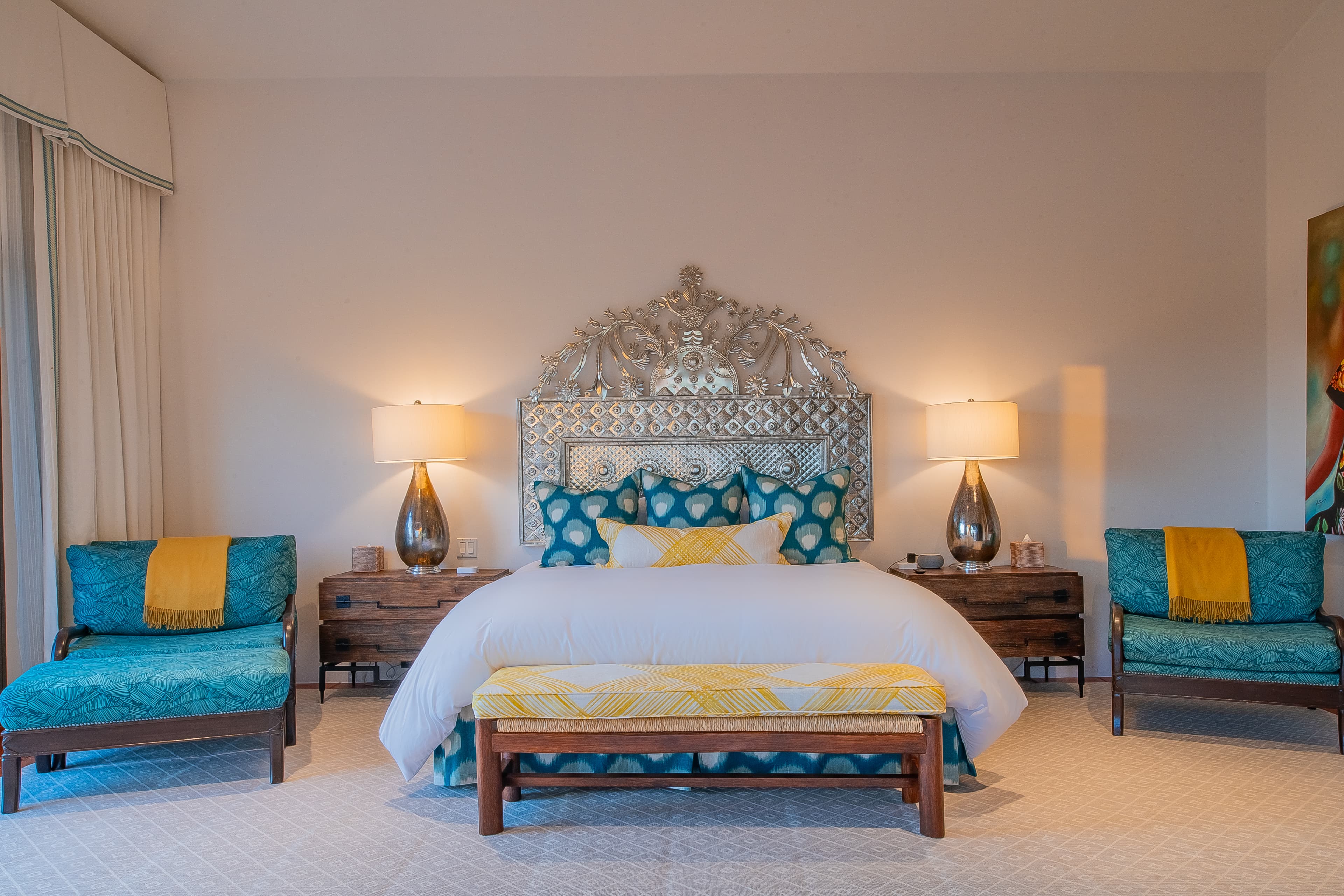 Bedroom 3 · Sink into crisp linens and plush pillows in your serene bedroom, where vibrant accents and an ornate headboard create a space that feels both luxurious and welcoming.