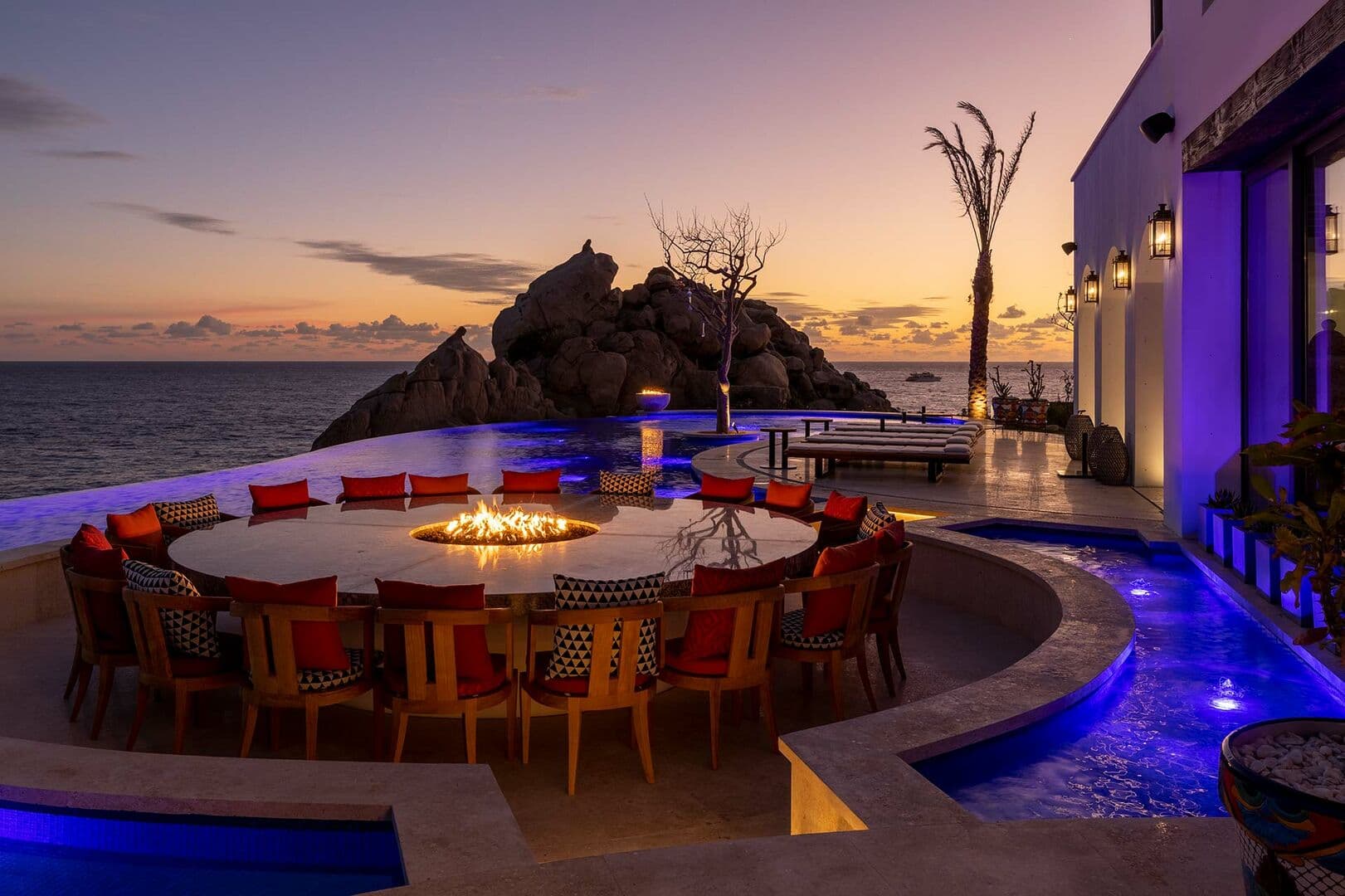 A sunset view of the table in the center of La Datcha's pool.