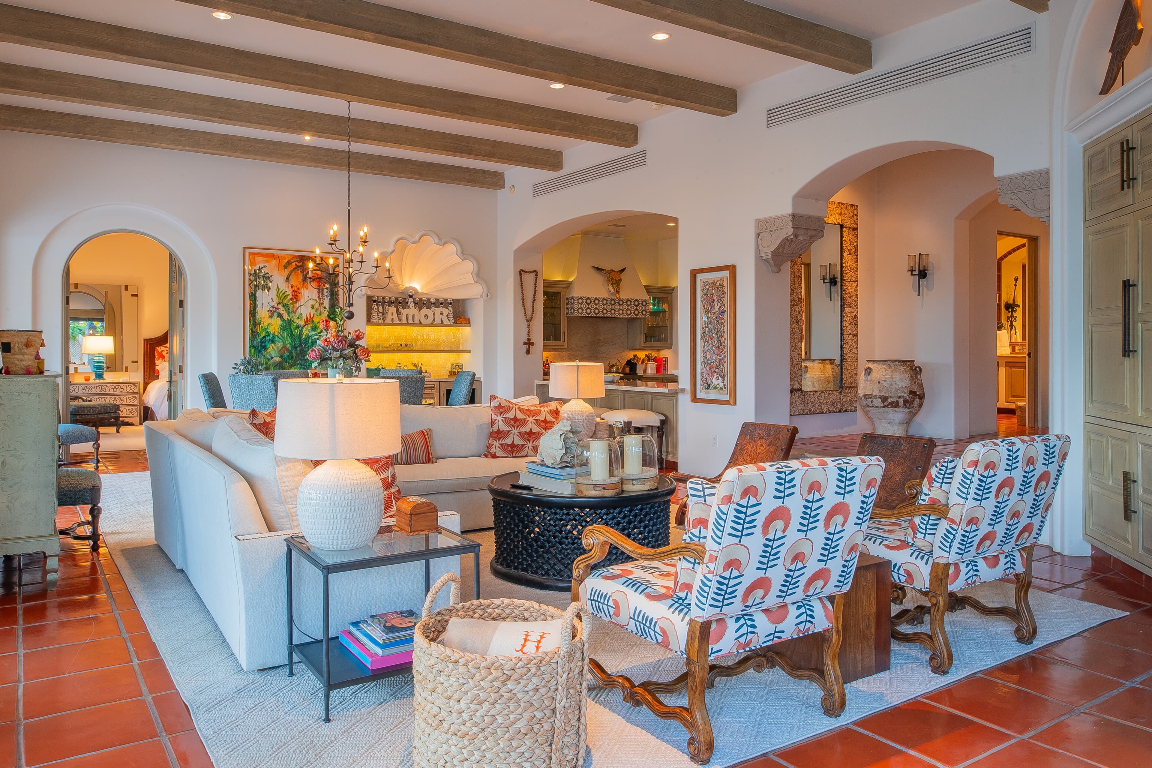 Vibrant archways and Spanish-style ceilings welcome you into this spacious living area, where plush seating, colorful accents, and curated artwork create a warm, inviting atmosphere for relaxation and conversation.