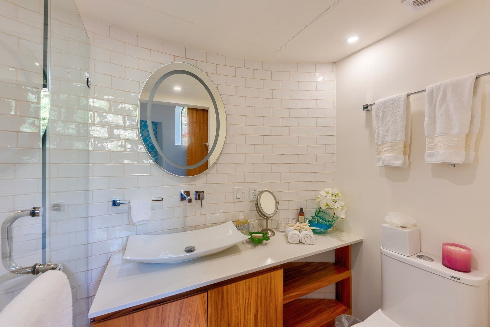 A bathroom with all white tile and bowl sink a bathroom in Villa Pura Vida.