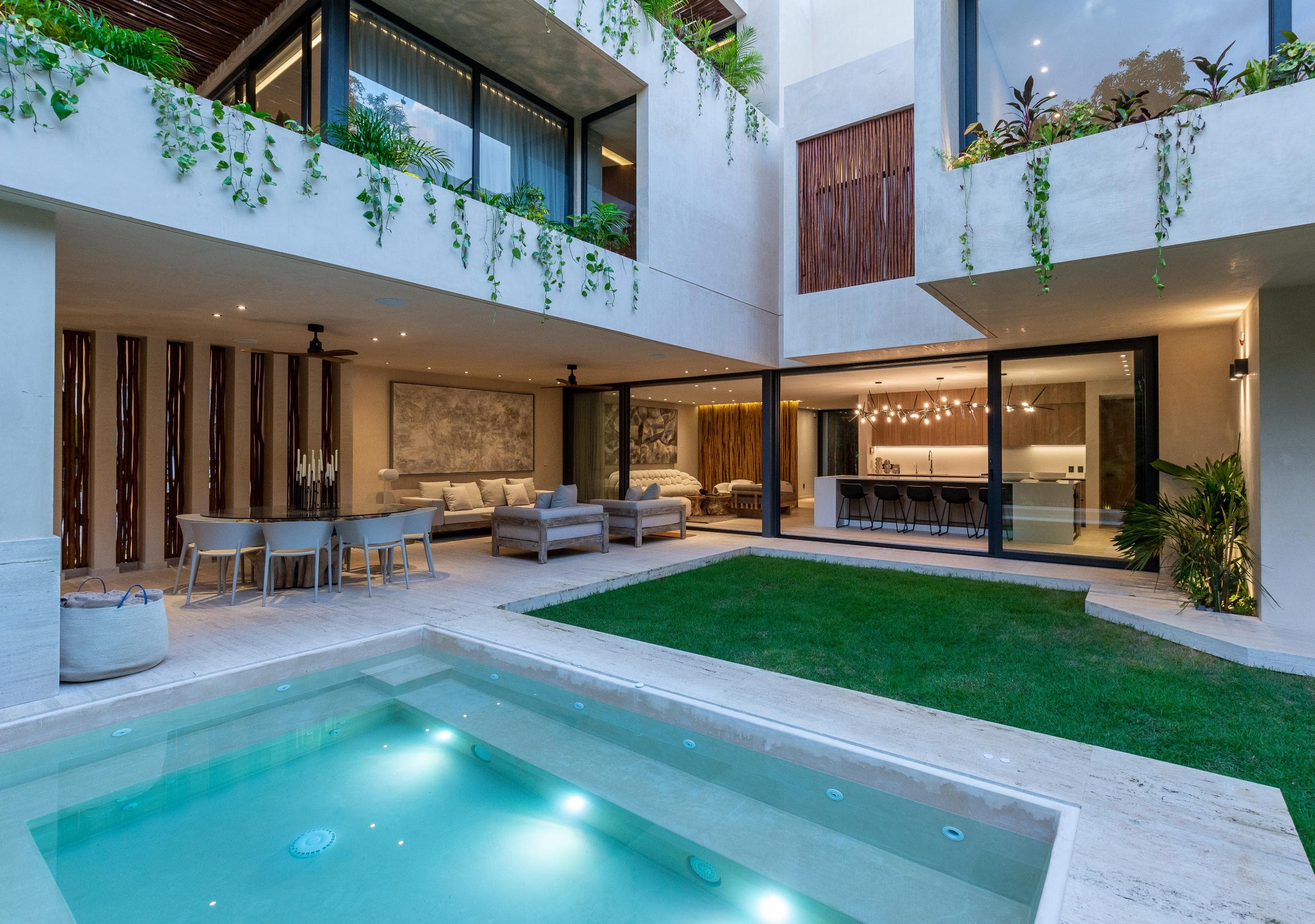 Modern house with pool, dining area, living room, and kitchen.